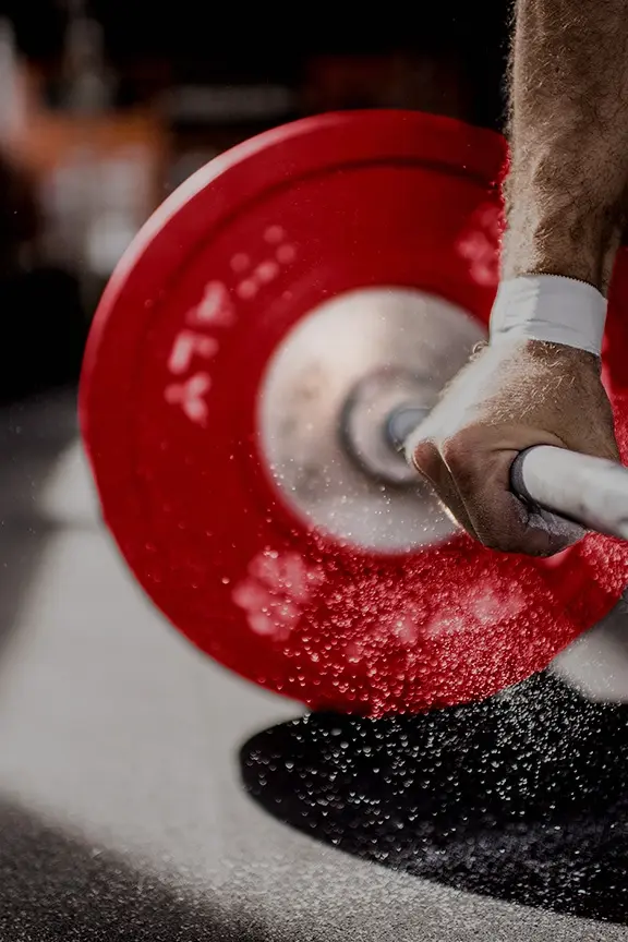 Man doing wallball against a wall with the CFB Logo